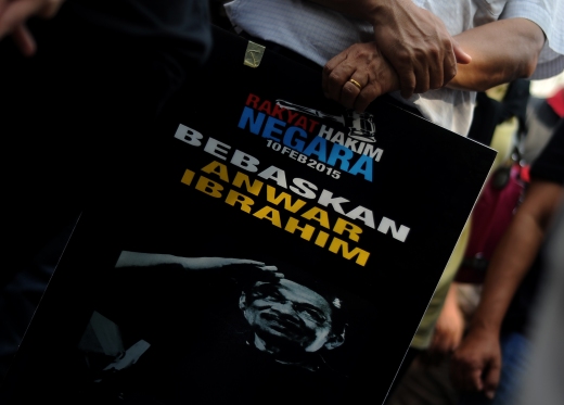 Supporter of Datuk Seri Anwar Ibrahim are seen holding a picture of  their leader while waiting decision of judges in front the Palace of Justice in Putrajaya.Datuk Seri Anwar Ibrahim will serve a five-year jail term from 10th Feb, 2015 after the Federal Court upheld the Court of Appeal’s earlier decision.Photo By Naem Ghazali.